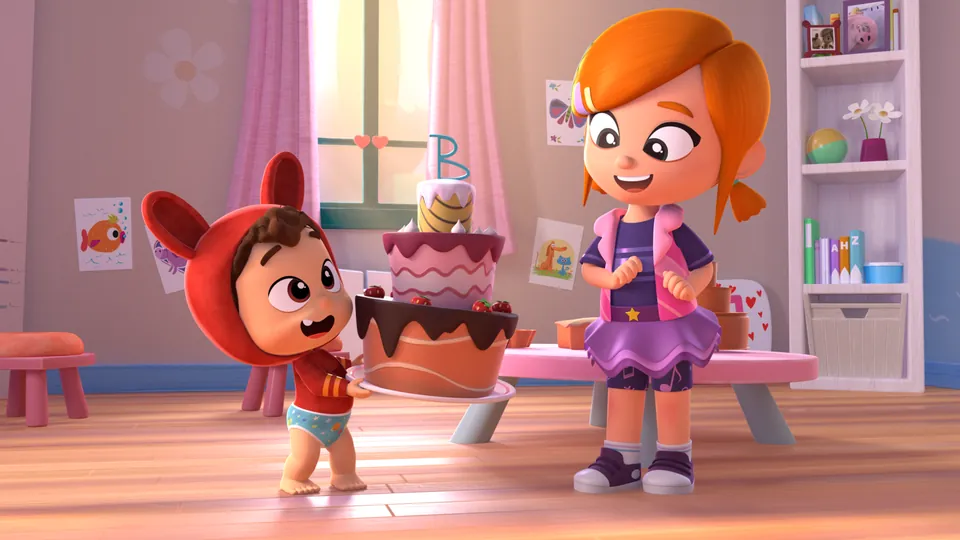 Lea y Pop con una tarta de cumpleaños gigante en su cuarto de juegos